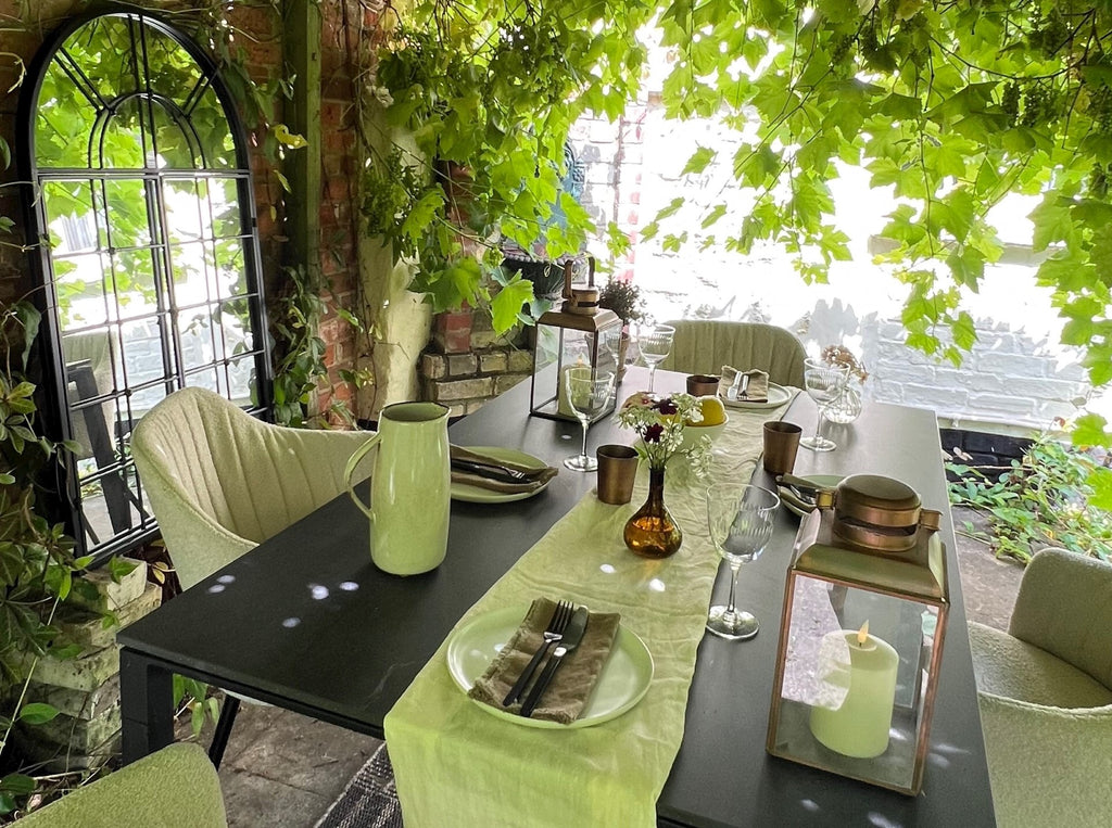 Pergola decor, dining setup, cosy decor, sand bouclé chairs, design ceramic black outdoor dining table