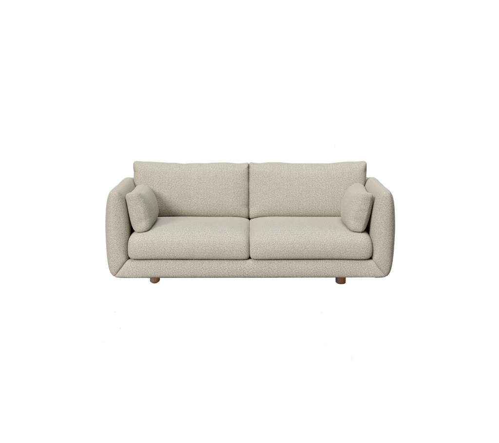 Lichtbruine moderne bank met ronde kussens in een minimalistische stijl.