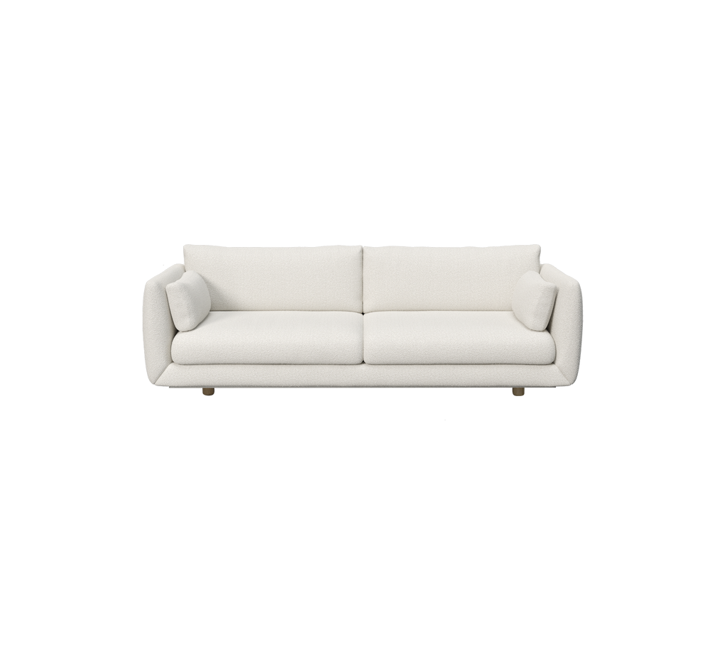 Moderne witte bank met cilindervormige kussens.