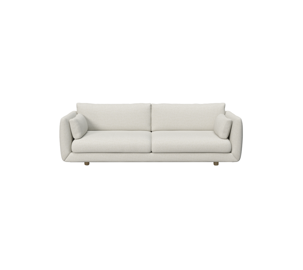 Moderne zandkleurige sofa met ronde kussens.