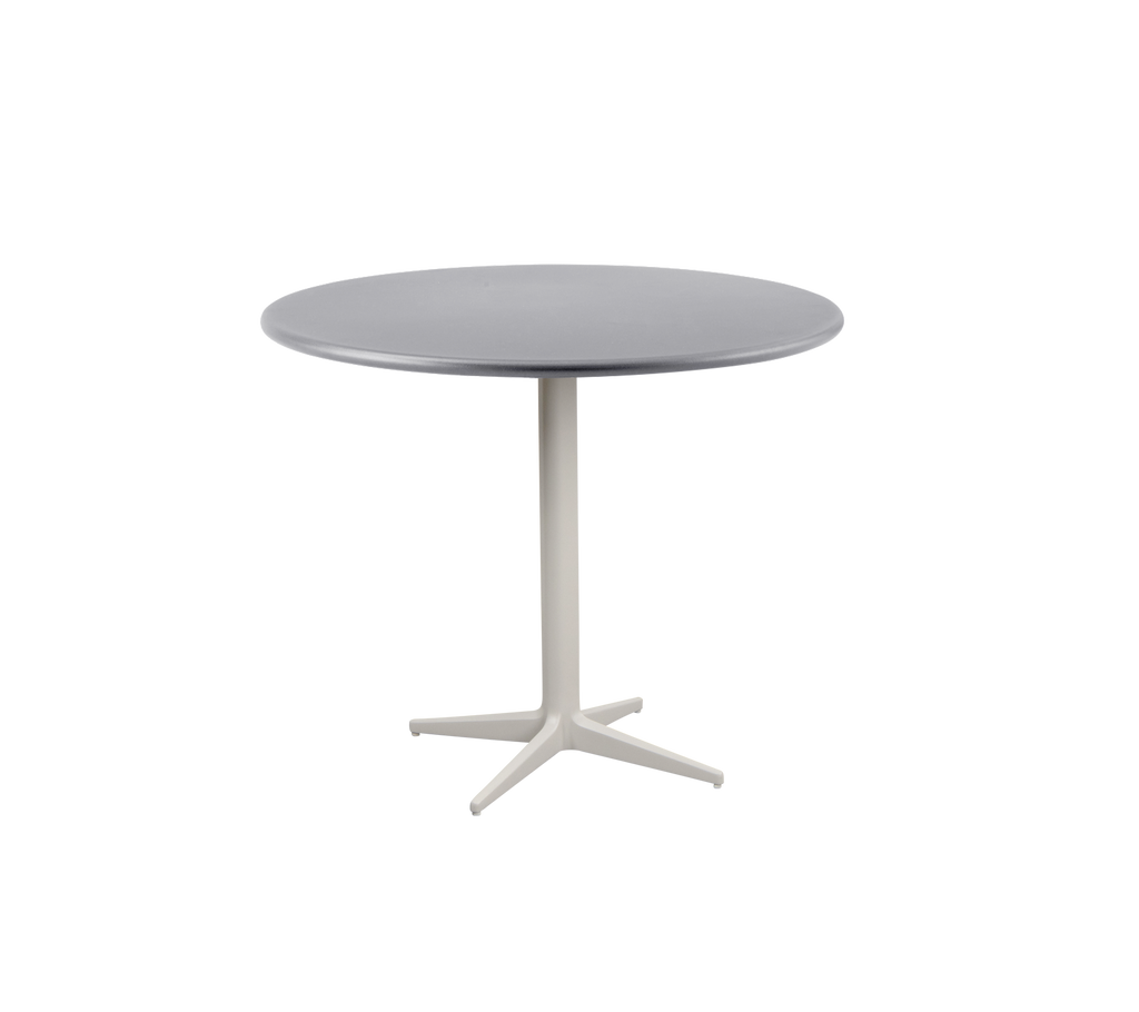 Modern ronde tafel met een gladde grijze bovenkant en een stevige, lichtgekleurde basis met een vierpoots ontwerp.
