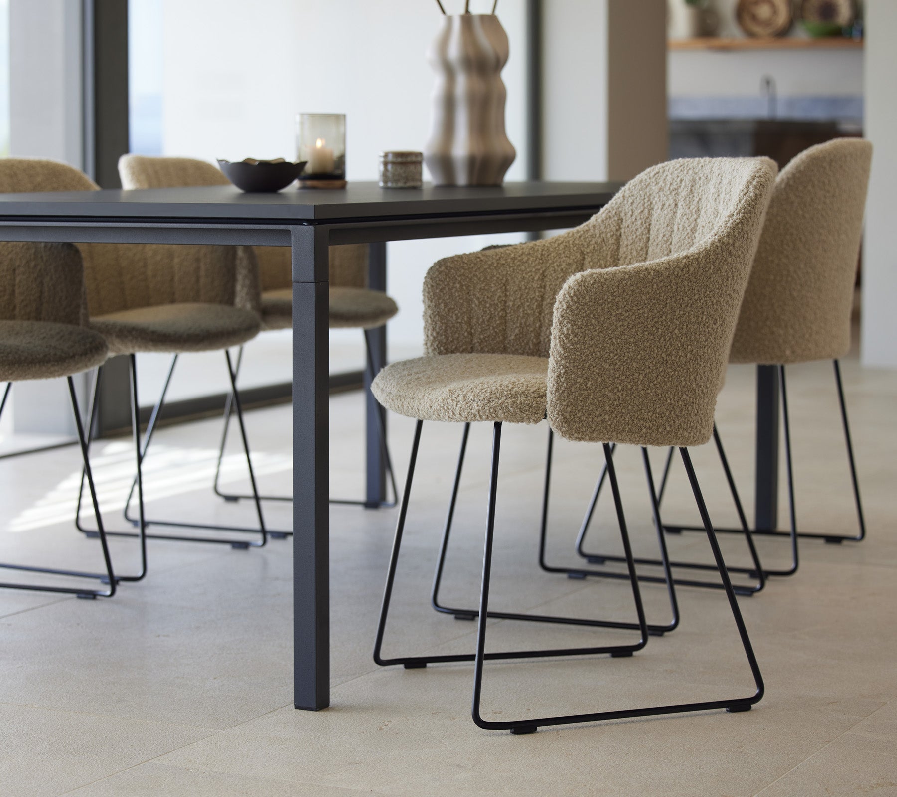 Een stijlvolle eettafel met tekstuurlijke stoelen, met een modern design en minimalistische elementen, klaar voor een uitnodigende eetervaring.